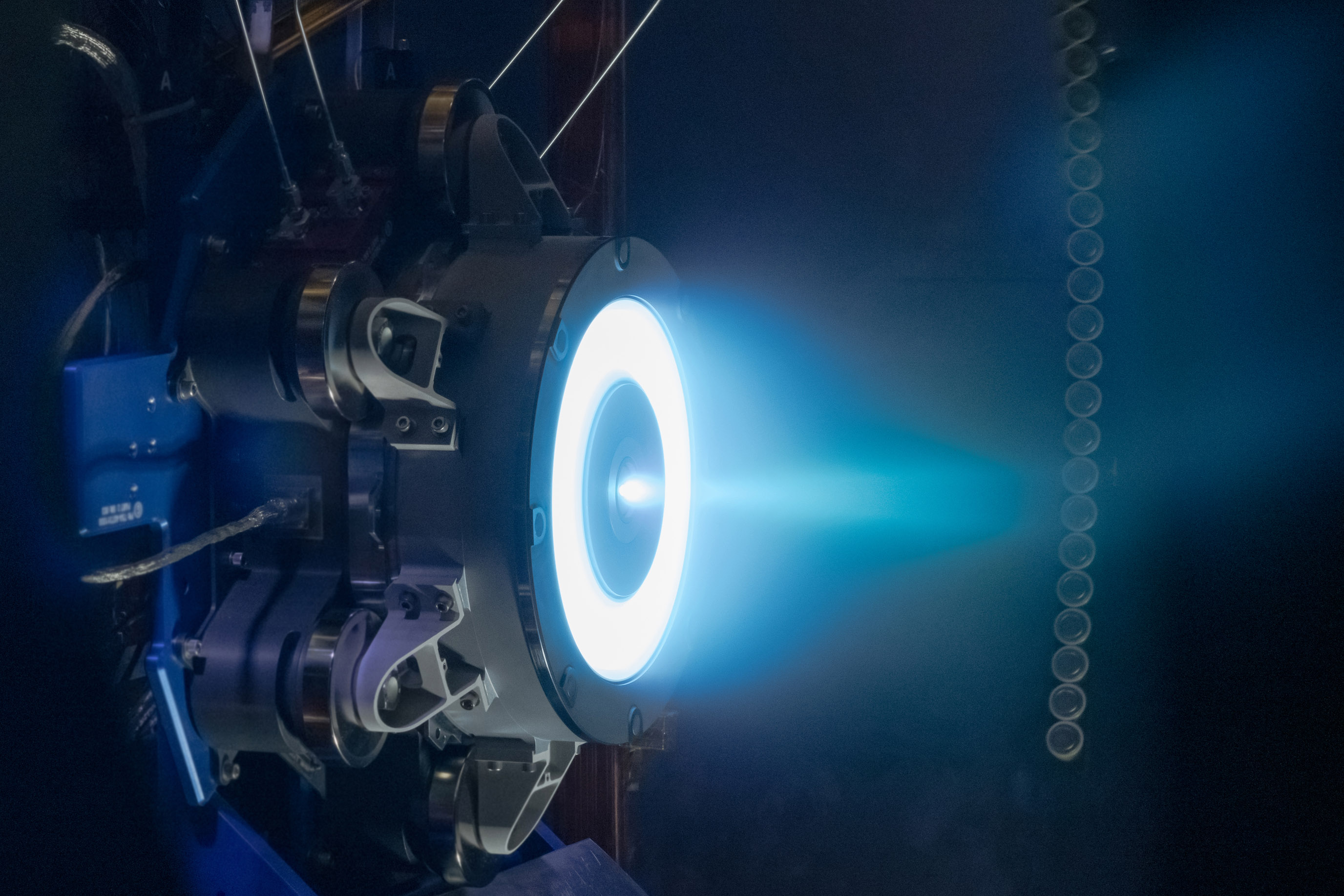 Electric thruster firing in a vacuum chamber